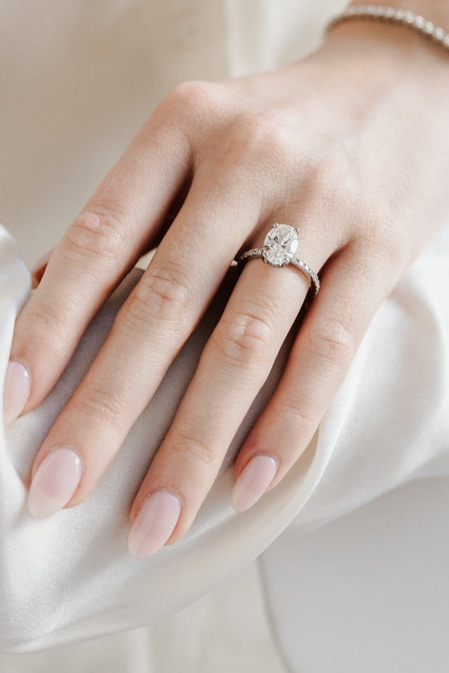 Oval solitaire engagement ring with pave band - platinum