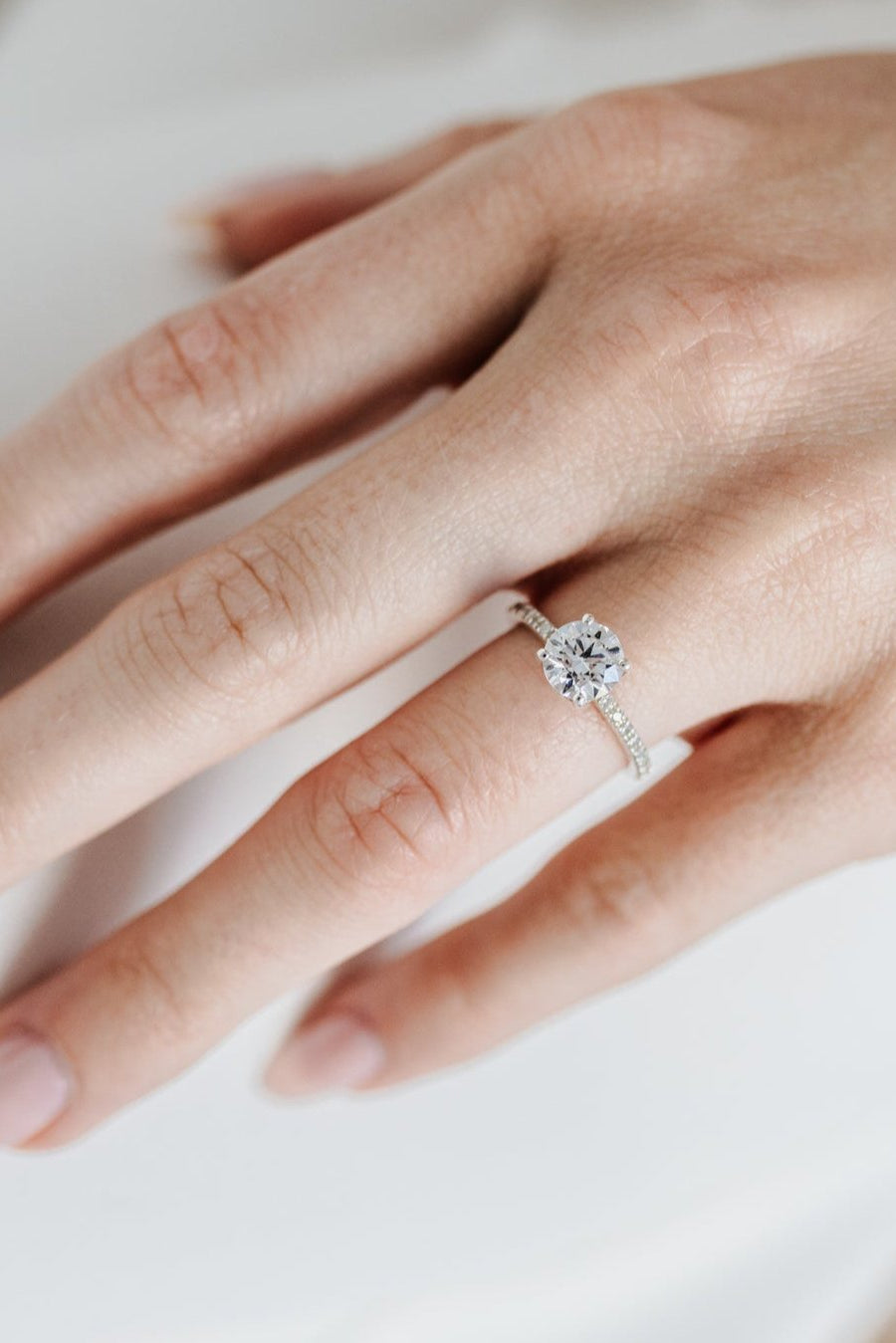 Round solitaire engagement ring with pave band - platinum