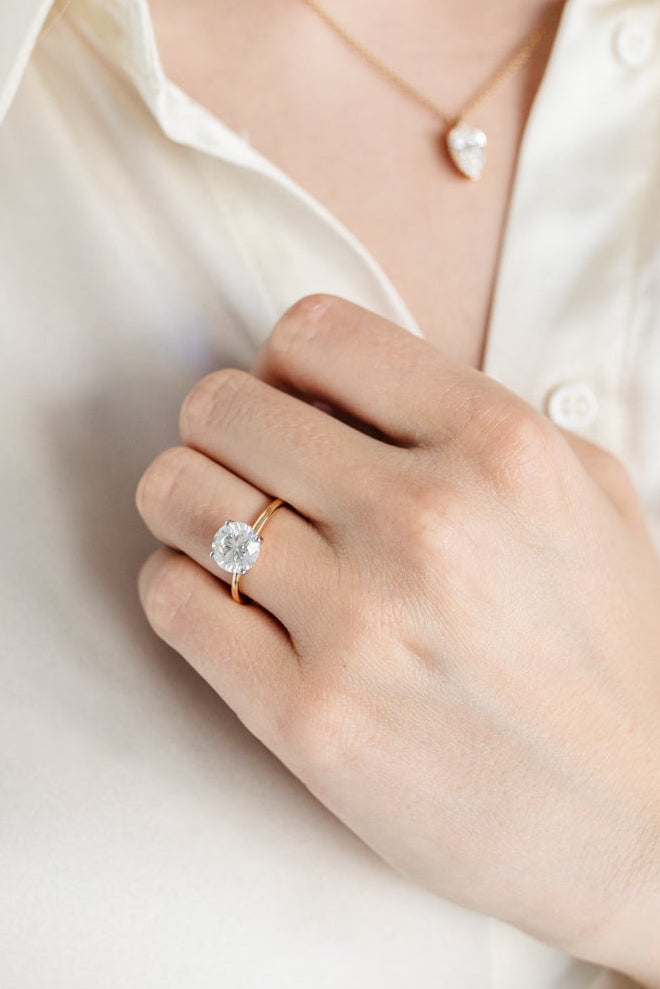 Round solitaire engagement ring - 18-karat yellow gold with platinum prongs